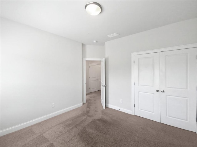 unfurnished bedroom featuring a closet and carpet flooring