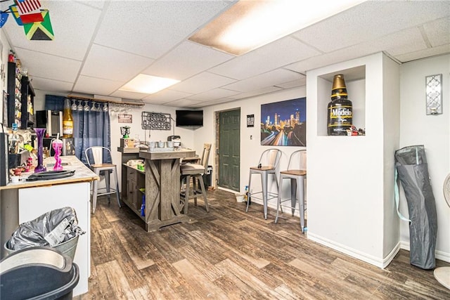5843 Foxfield Trl, Rex, GA 30273 - bar area with wood finished floors, a paneled ceiling, and baseboards