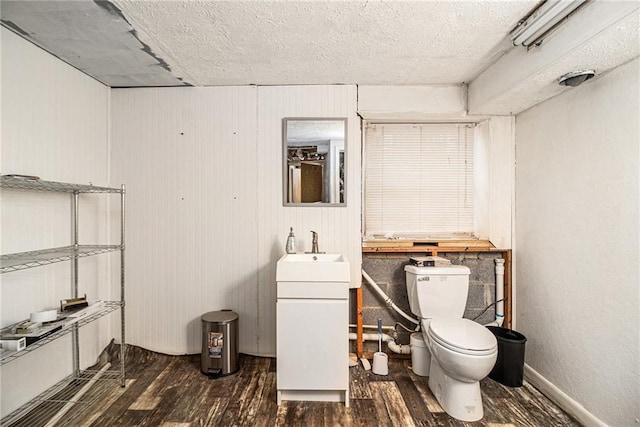 5843 Foxfield Trl, Rex, GA 30273 - bathroom with wood finished floors, toilet, a textured ceiling, and vanity