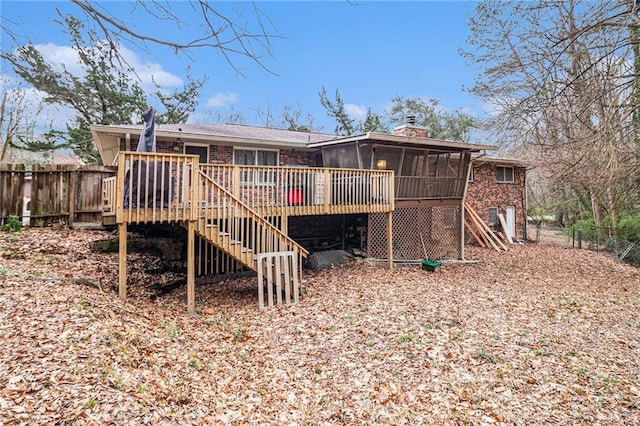 5843 Foxfield Trl, Rex, GA 30273 - rear view of property featuring stairway, a sunroom, a wooden deck, and brick siding