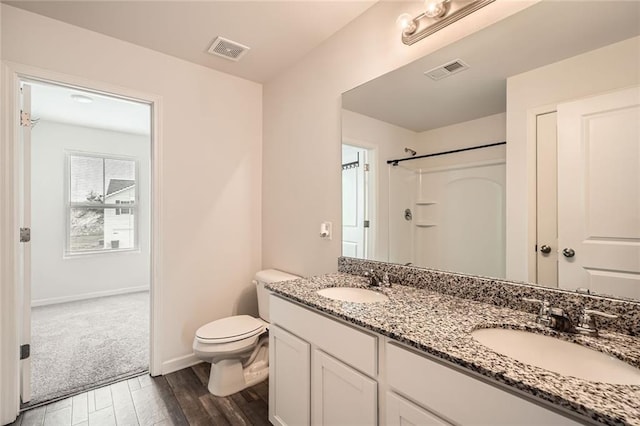 full bath featuring toilet, visible vents, and a sink