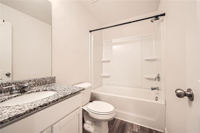 full bath featuring vanity, shower / tub combination, wood finished floors, and toilet