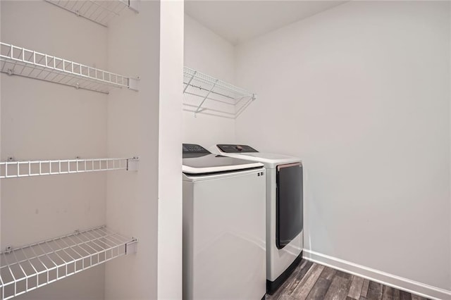 laundry room with baseboards, laundry area, dark wood-style flooring, and washer and dryer