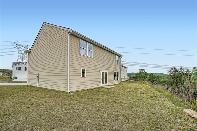 view of side of home with a yard
