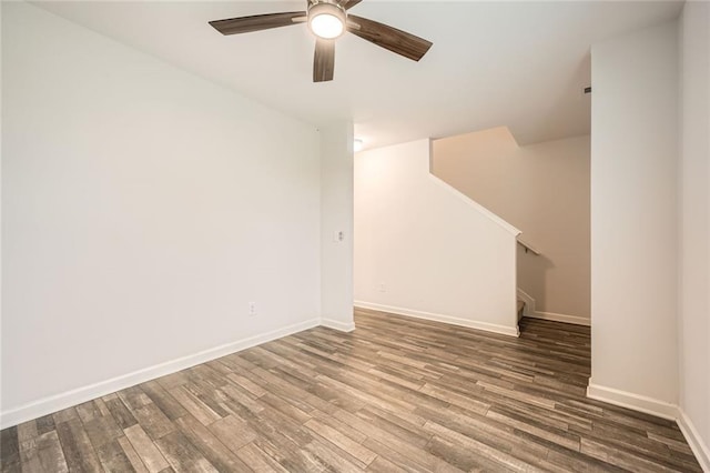 basement with baseboards, stairs, ceiling fan, and wood finished floors
