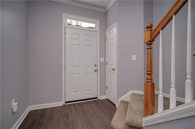 foyer entrance featuring stairway, baseboards, dark wood finished floors, and ornamental molding