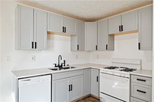 kitchen featuring sink, white appliances, and gray cabinets