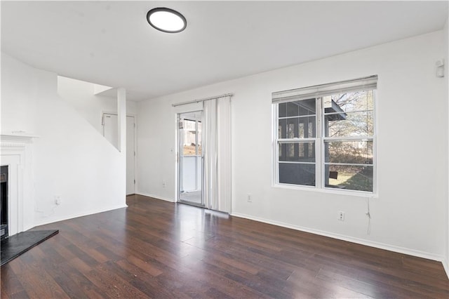 unfurnished living room featuring dark hardwood / wood-style flooring