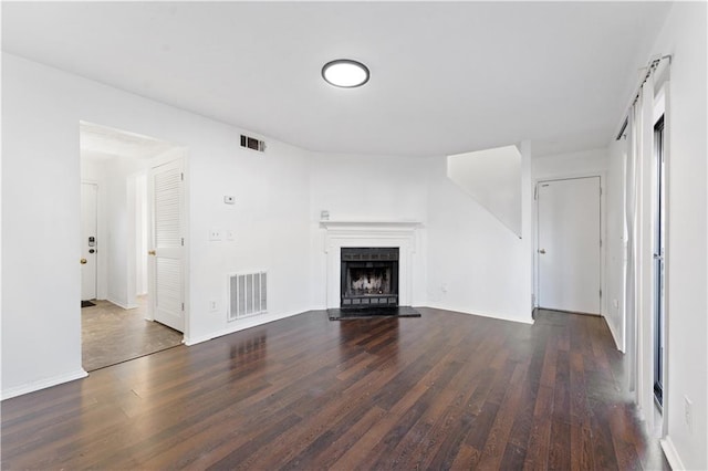 unfurnished living room with dark hardwood / wood-style floors