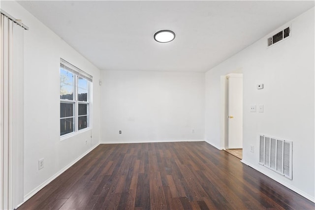 unfurnished room with dark wood-type flooring