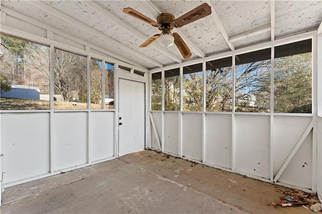 unfurnished sunroom featuring ceiling fan