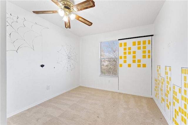 carpeted empty room with ceiling fan