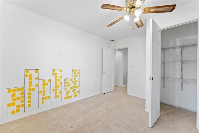 unfurnished bedroom featuring light colored carpet, a closet, and ceiling fan