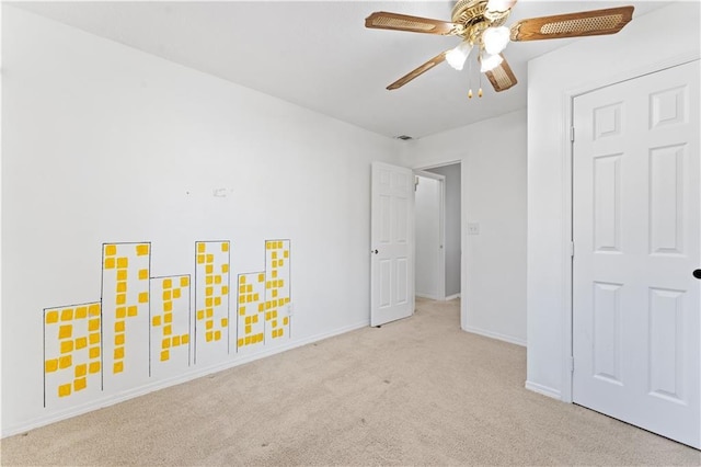 unfurnished bedroom featuring ceiling fan and light colored carpet