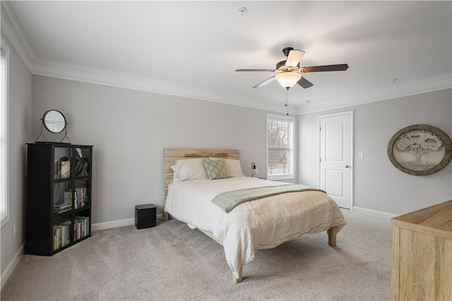 carpeted bedroom with crown molding and ceiling fan