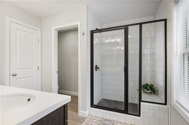 bathroom featuring vanity, hardwood / wood-style flooring, a shower with door, and toilet