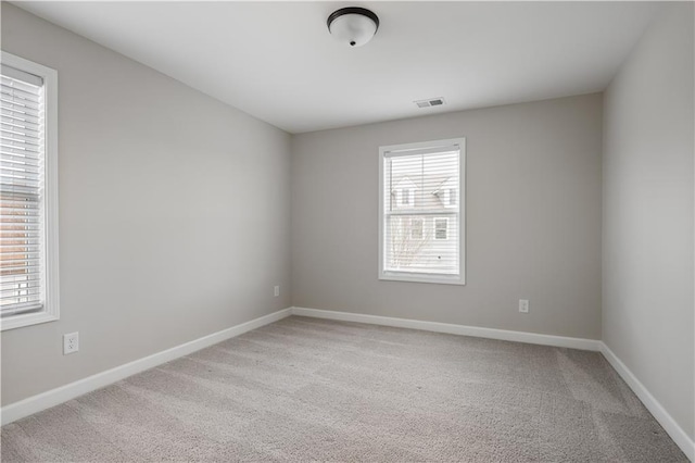 unfurnished room with light carpet