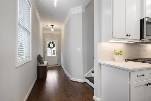 hallway featuring dark hardwood / wood-style flooring and ornamental molding