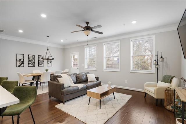 living room with crown molding, dark hardwood / wood-style floors, and ceiling fan