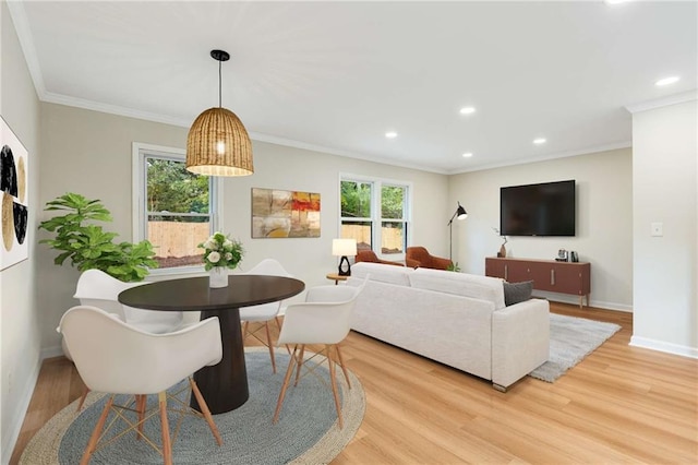 living room with light hardwood / wood-style flooring and ornamental molding