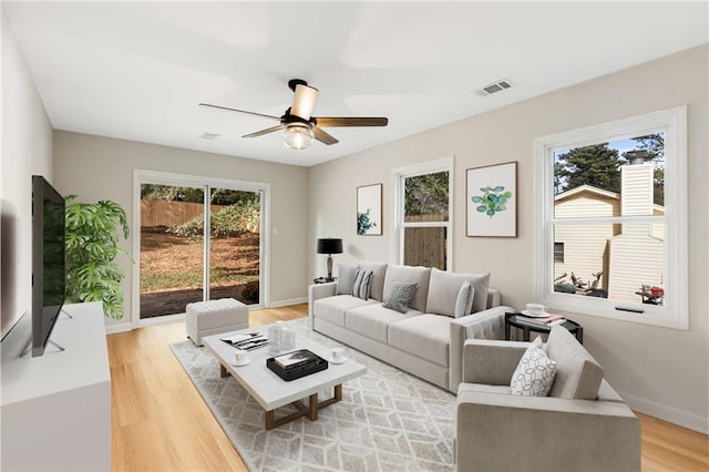 living room with ceiling fan and light wood-type flooring