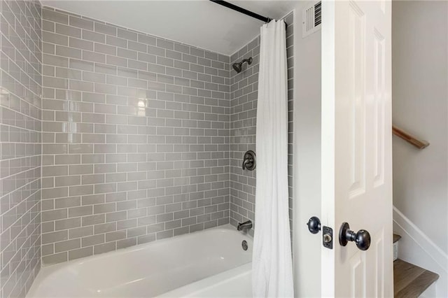 bathroom with shower / bath combo with shower curtain