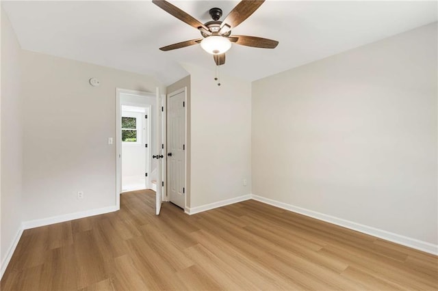 spare room with ceiling fan and light wood-type flooring