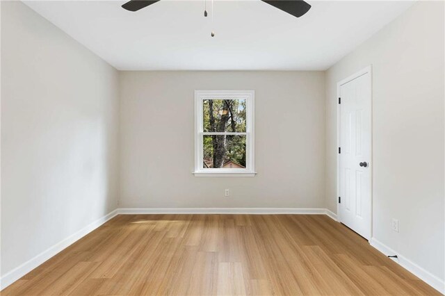 spare room featuring ceiling fan and light wood-type flooring