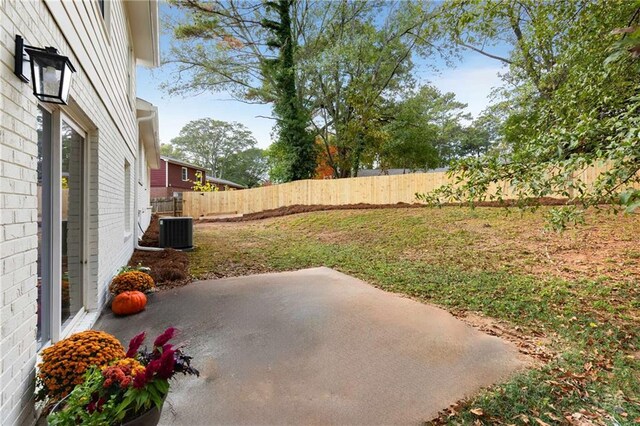 view of yard with a patio and central AC unit