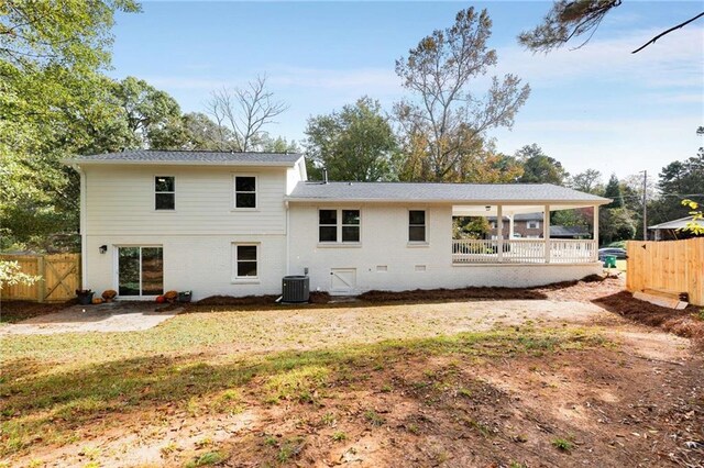 back of house featuring a lawn and central AC