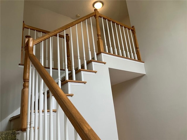 stairs featuring a high ceiling