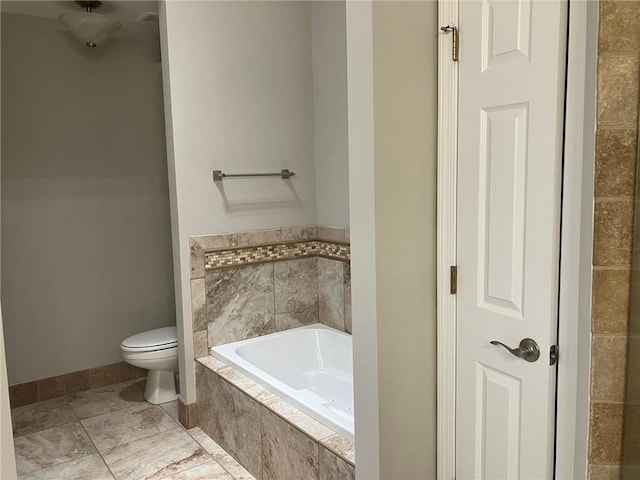 bathroom with a relaxing tiled tub and toilet