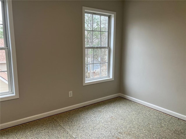 unfurnished room featuring a wealth of natural light