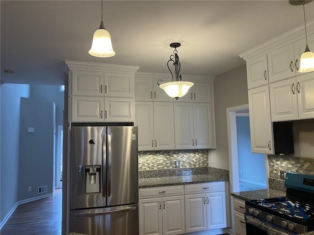 kitchen featuring white cabinetry, stainless steel appliances, and hanging light fixtures