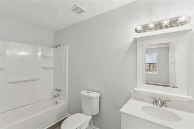 full bathroom featuring vanity, shower / tub combination, toilet, and a textured ceiling