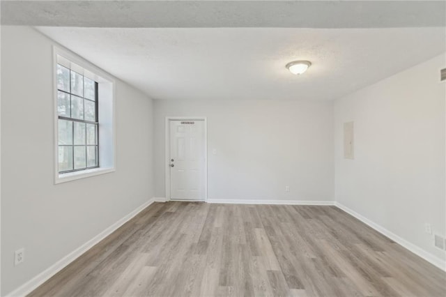 unfurnished room featuring light hardwood / wood-style flooring