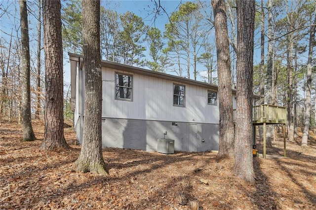 view of home's exterior featuring a wooden deck and central AC unit