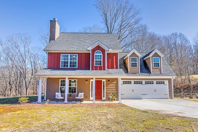 view of front of property with a front yard, covered porch, and a garage