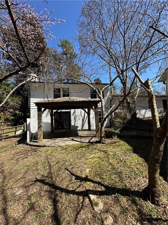 rear view of property with a patio area and fence