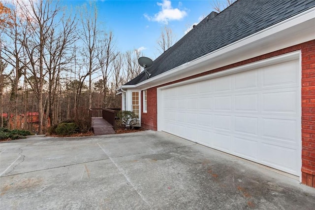 816 Ivy Ridge Dr, Loganville, GA 30052 - view of side of property featuring brick siding, a shingled roof, and driveway
