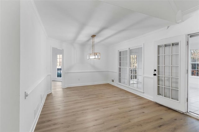 816 Ivy Ridge Dr, Loganville, GA 30052 - unfurnished dining area with ornamental molding, light wood-style flooring, a chandelier, and baseboards
