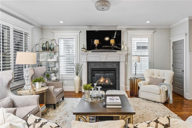 living room featuring a fireplace, hardwood / wood-style floors, and crown molding