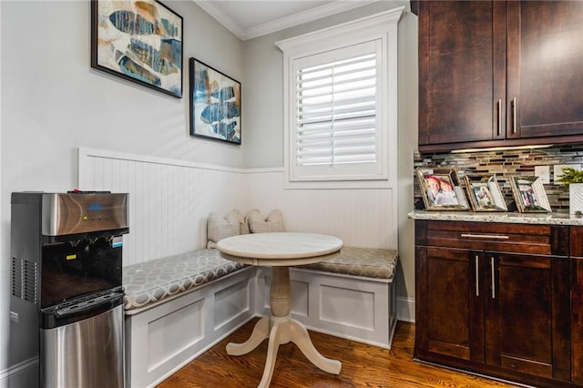 interior space with ornamental molding, dark wood-type flooring, and breakfast area