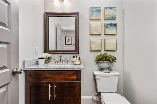 bathroom featuring toilet and vanity