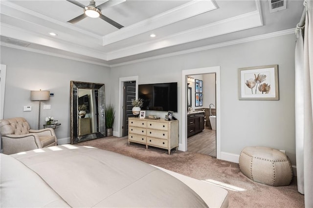 bedroom with ensuite bath, ceiling fan, crown molding, and a raised ceiling