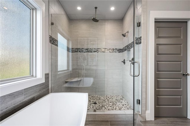 bathroom with separate shower and tub