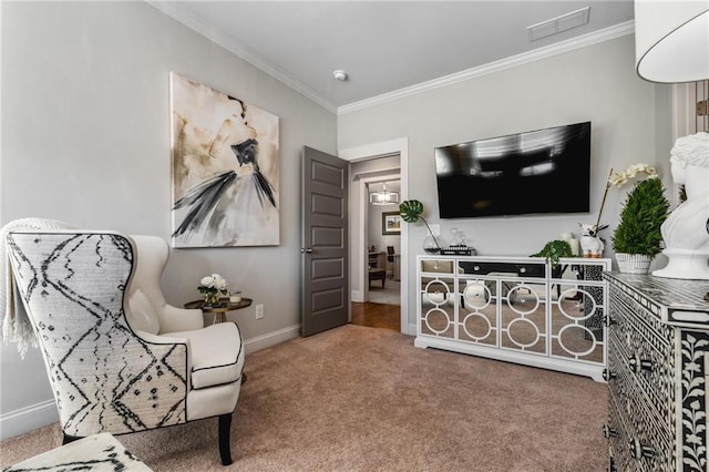 sitting room featuring ornamental molding and carpet