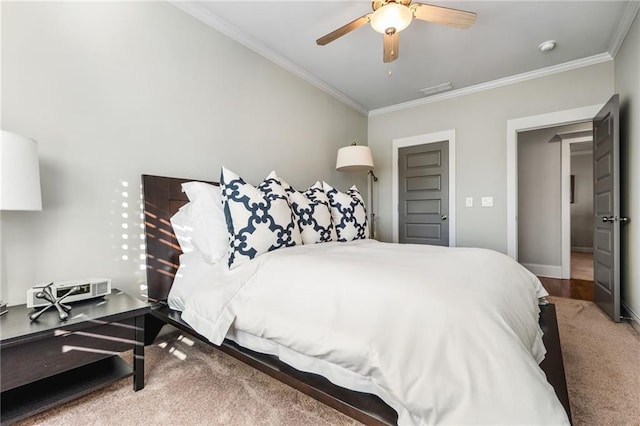 bedroom featuring ceiling fan, carpet, and ornamental molding