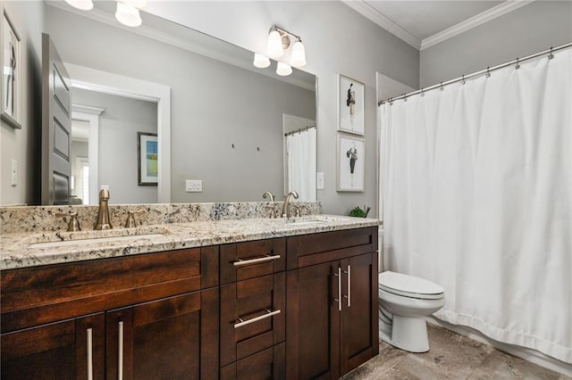 bathroom with toilet, vanity, and ornamental molding