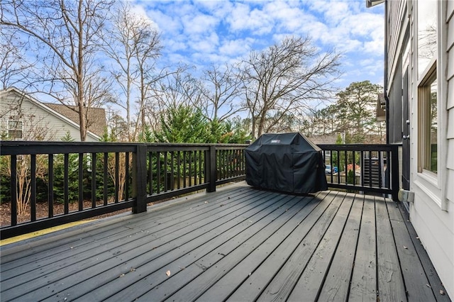 wooden terrace featuring a grill